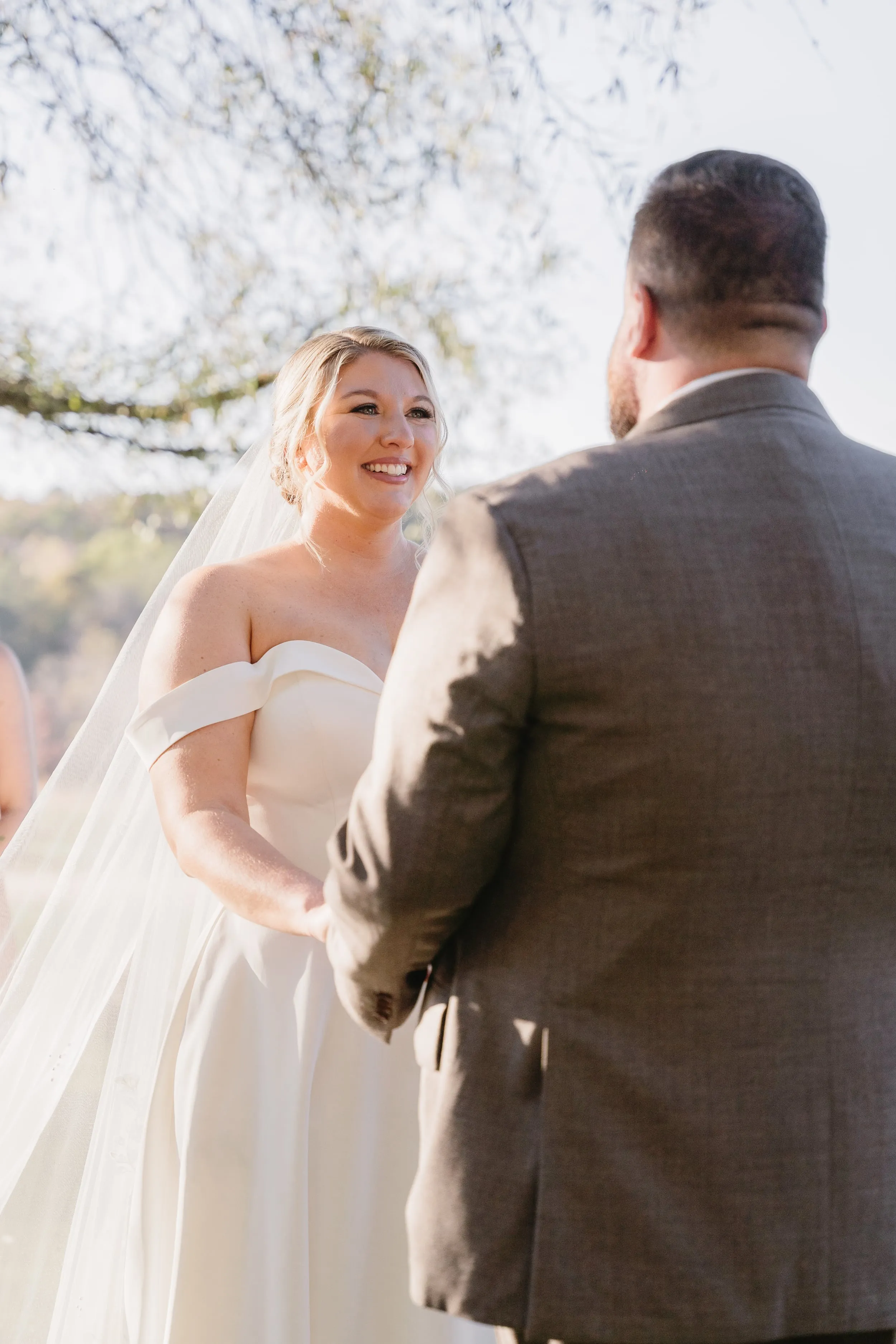 Wedding couple sharing a tender moment outdoors