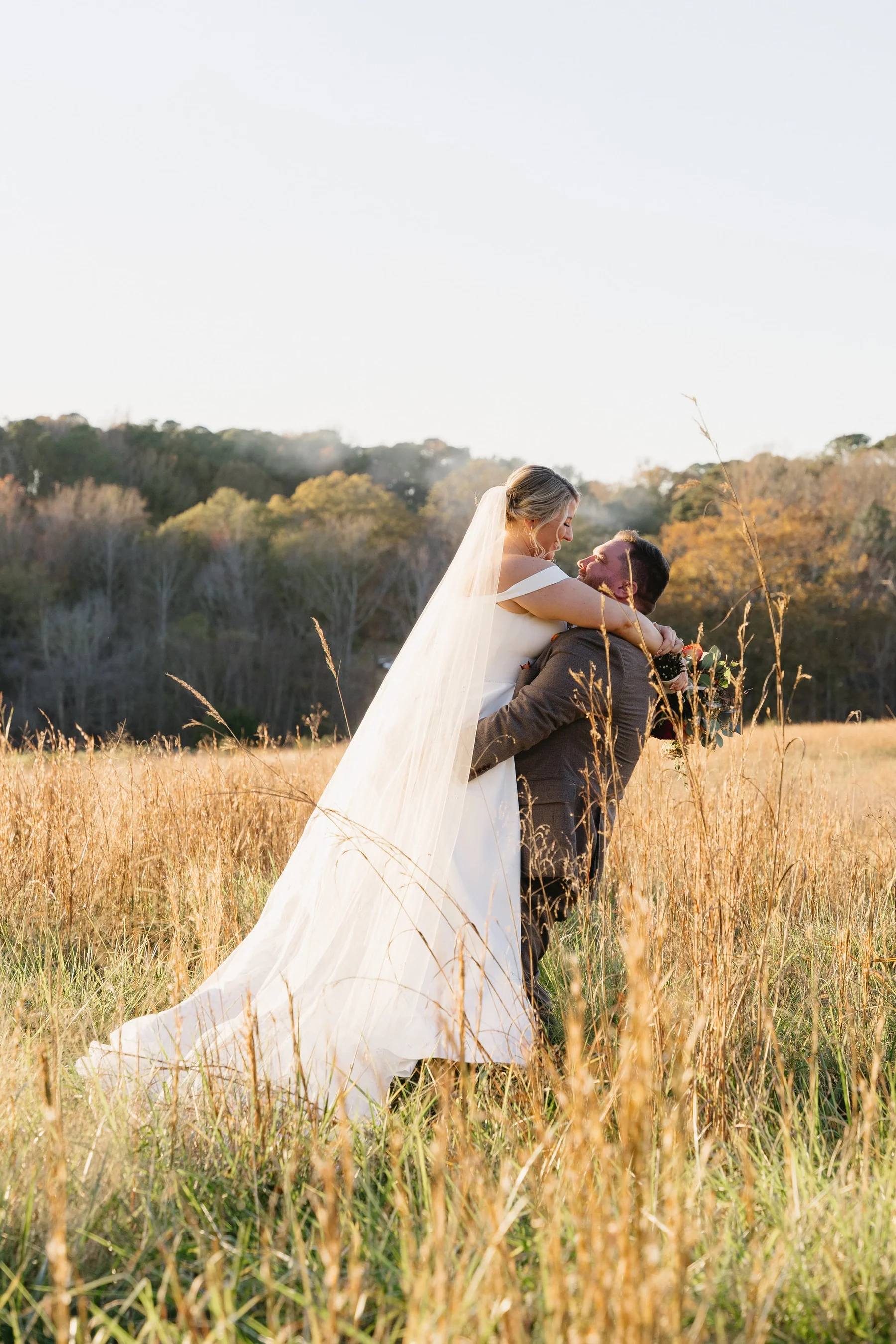 A beautifully captured wedding moment — bride and groom surrounded by warm, cinematic light